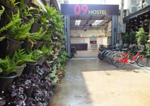 a store with a bunch of plants on the wall at 09 Hostel in Chiang Mai