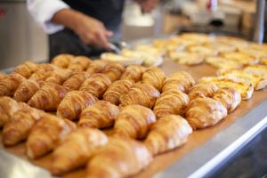 a bunch of donuts on a counter in a bakery at Grupotel Club Menorca in Son Xoriguer