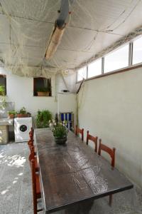 Zimmer mit einem langen Holztisch und Stühlen in der Unterkunft Casetta Liberty in Grado