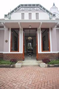 a building with a front entrance with a brick patio at Huis Van Gustafine Floor 2 in Malang