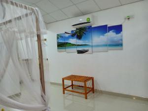 a room with a table and paintings on the wall at Victory Villa Sigiriya in Sigiriya