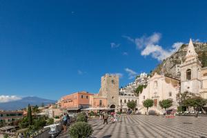 a view of a town with a mountain in the background at Varò Apartment in Taormina