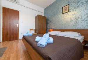 a bedroom with a large bed with towels on it at Guesthouse Jasna in Slano