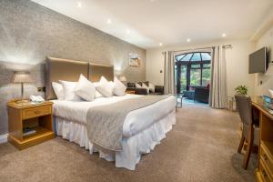 a bedroom with a large bed and a living room at Le Friquet Hotel in Castel