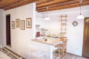 a kitchen with white walls and wooden ceilings at Romantic studios in Rovinj