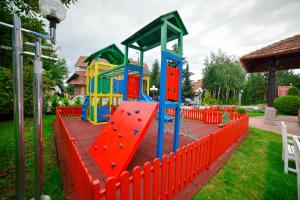 a playground with a play equipment in a yard at Vila Romantika in Zlatibor