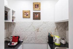 a kitchen with a black counter and a wall with pictures at Apartment Near Trevi Fountain in Rome