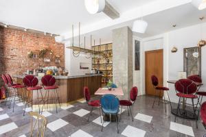a room with a bar with red chairs and a counter at Bahar Boutique Hotel in Thessaloniki