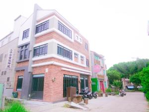 a tall brick building on a city street at Miss inn in Magong