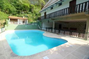 a large blue swimming pool in a house at Casa da Verdasca by Gerês Casas in Geres