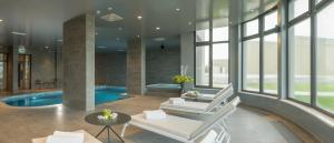 a living room with a pool and a white chair at Hotel Princess in Jastrebarsko