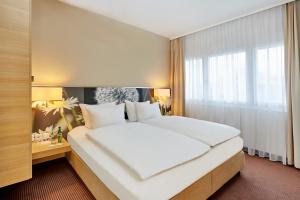 Ein Bett oder Betten in einem Zimmer der Unterkunft H+ Hotel Zürich