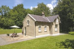 a small building with a table and an umbrella at Schoolhouse at Annaghmore in Collooney