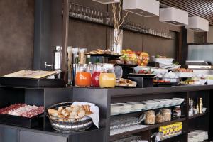 a buffet line with food and drinks on display at The Independent Suites in Rome