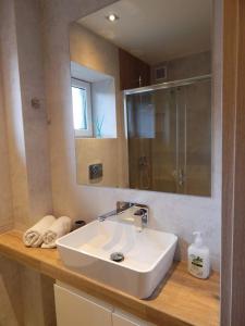 a bathroom with a white sink and a mirror at Apartament Malwina in Polanica-Zdrój +41 photos