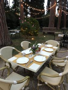 a white table with chairs and lights in a yard at Villa Rosella Resort in Roseto degli Abruzzi