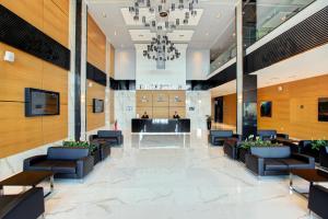 a lobby of a hotel with chairs and a chandelier at Merit Grand Mosta Spa Hotel & Casino in Svilengrad