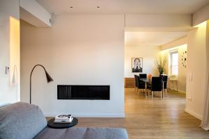 a living room with a couch and a tv on a wall at Central Acropolis View Apartment in Athens