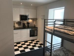 a small kitchen with a bunk bed in a room at Smultronstallet Gårdshotell in Valleberga