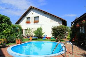 a swimming pool in front of a house at Holiday house Morávkovi in Horní Branná