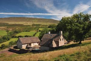 an old house on a hill in a field at The House In The Hills in Velindre