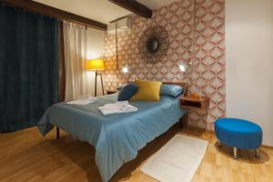 a bedroom with a blue bed and a blue chair at Pietrapiana flat & local market in Florence