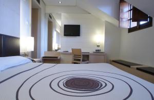 Postel nebo postele na pokoji v ubytování Hotel Mozart
