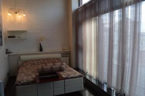 a bedroom with a bed and a large window at The Volga House Boutique-Hotel in Kazan