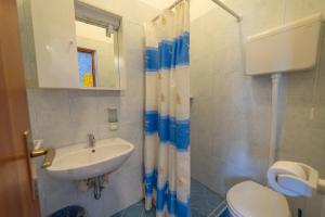 a bathroom with a toilet and a sink at Guesthouse Jasna in Slano +26 photos