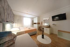 a hotel room with a bed and a couch at Central Apartments Integrated Hotel in Zadar