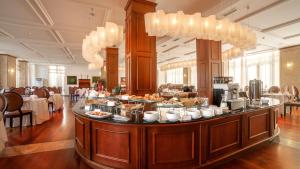 a buffet line with food on a table in a restaurant at Kobuleti Georgia Palace Hotel & Spa in Kobuleti