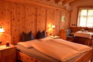 a bedroom with a large bed with wooden walls at App. Birkenheim in Valdaora