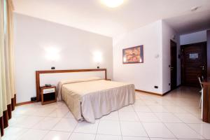 Postel nebo postele na pokoji v ubytování Hotel & Residence La Sibilla Cusiana