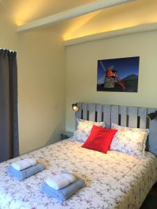 a bedroom with a bed with two towels on it at Casa do Almance in São João