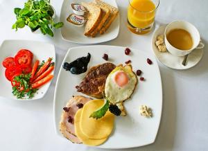 a plate of food with eggs and toast and a cup of coffee at IRS ROYAL APARTMENTS Apartamenty IRS Fregata in Gdańsk