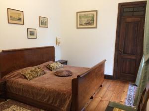 a bedroom with a bed and a wooden floor at Ēdoles Pils in Ēdole