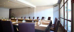 a conference room with a long table and chairs at Best Western Le Pont d'Or in Figeac +91 photos