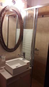 a bathroom with a sink and a mirror at Archontiko Koilia in Makrinítsa +49 photos
