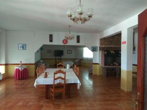 a dining room with a table and chairs and a fireplace at Joaquim do Norte in Podence
