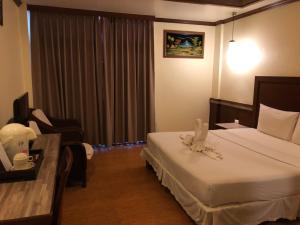 Postel nebo postele na pokoji v ubytování Mac Resort Hotel