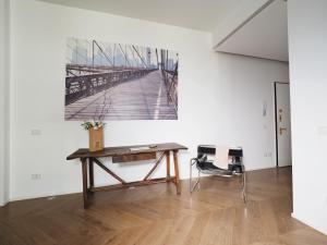 a table and chairs in a room with a painting on the wall at Turati 3 in Milan