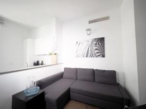 a living room with a couch and a zebra picture at Turati 3 in Milan