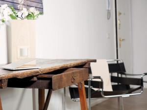 a wooden desk with a laptop on top of it at Turati 3 in Milan