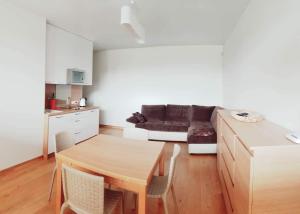 a living room with a table and a couch at Ramresort Apartment Palanga in Palanga