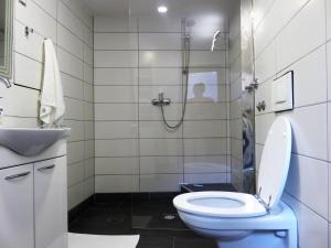 a bathroom with a shower with a toilet and a sink at Apartman in Cres +21 photos