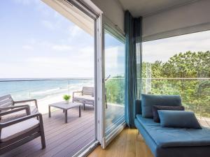 a living room with a couch and a view of the ocean at VacationClub - Przy Plaży Apartament 22 in Mielno