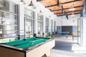 a billiard room with a pool table in a building at Archipelag in Ustka