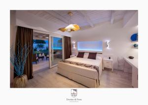 a bedroom with a bed and a view of the ocean at Destino di Nora in Pula +42 photos