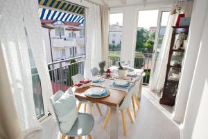 a dining room with a table and chairs on a balcony at Apartment Leonardo in Rovinj