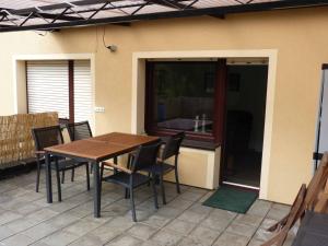 a wooden table and chairs on a patio at Ferienwohnung Moselblick in Ediger-Eller +10 photos